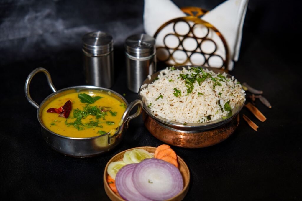 A tantalizing display of Indian rice and dal tadka with spices, perfect for food lovers.