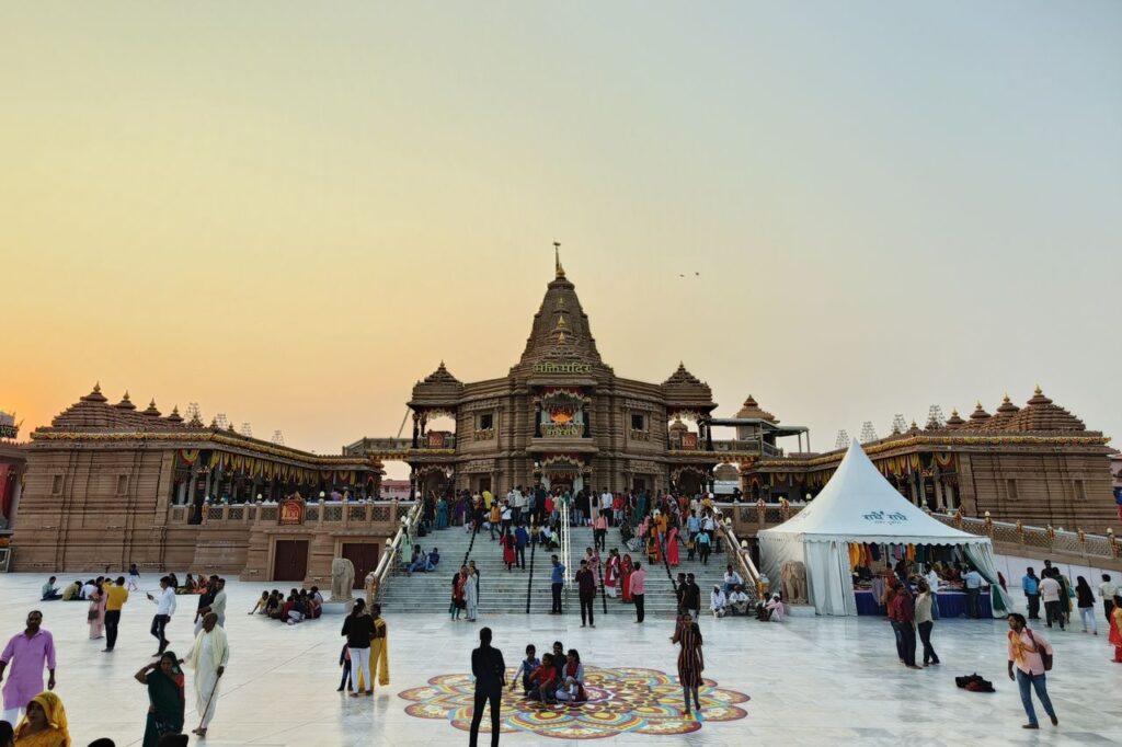A lively scene at a famous temple with people gathering during sunset.